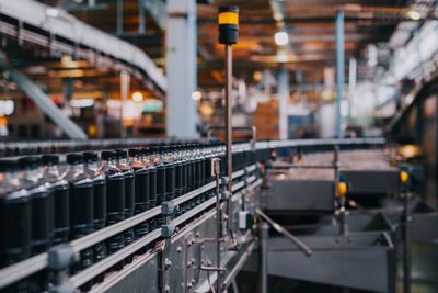 Liquid in bottles on machinery at factory