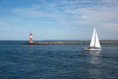 Sailboat in sea against sky