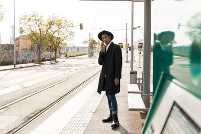 Man standing at railroad station