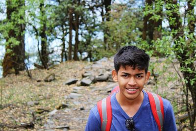 Portrait of smiling young man in forest