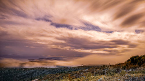 Scenic view of field against sky during sunset