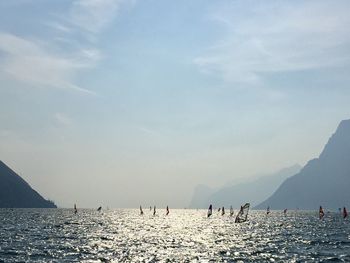 Group of people on beach against sky