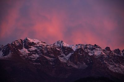 Scenic view of snowcapped mountains against sky during sunset