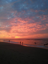 Scenic view of beach against sky during sunset