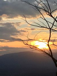 Scenic view of silhouette landscape against orange sky