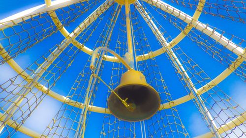 Low angle view of metallic structure against clear blue sky