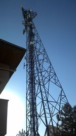 Low angle view of communications tower against sky