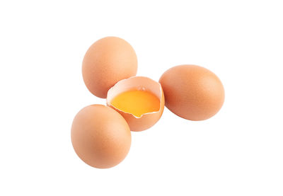 Close-up of eggs against white background