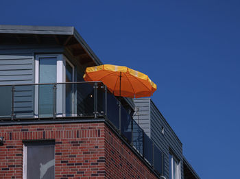 Low angle view of building against clear blue sky