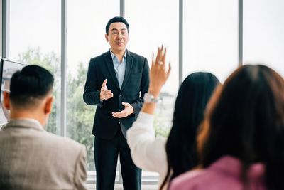 Side view of business people standing in office