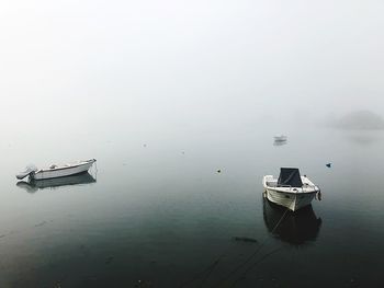 Ship moored in lake against sky