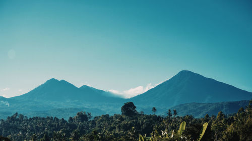 Scenic view of mountains against clear blue sky