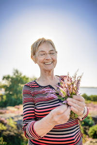 Senior woman holding wildflowers