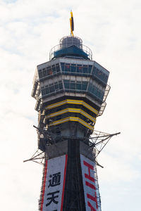 Low angle view of communications tower against sky