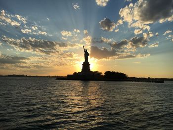 Statue of liberty against cloudy sky