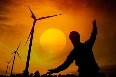 Silhouette man against orange sky during sunset