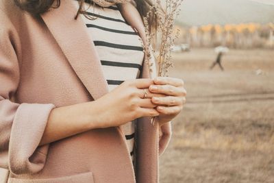 Midsection of woman holding plants