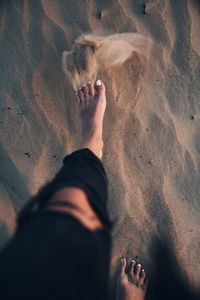 Low section of woman walking on beach