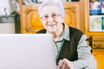 Portrait of happy man sitting on table