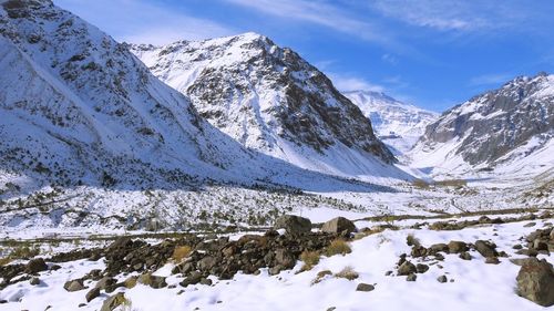 Scenic view of snow covered mountains against sky