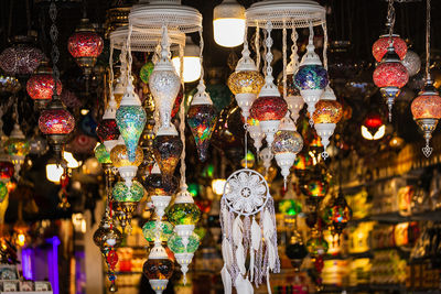 Illuminated lanterns hanging for sale in market