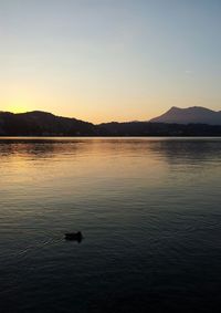 Scenic view of lake at sunset