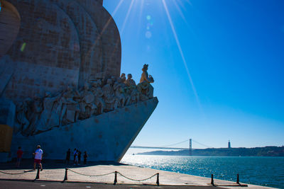 Monument next to sea with clear sky