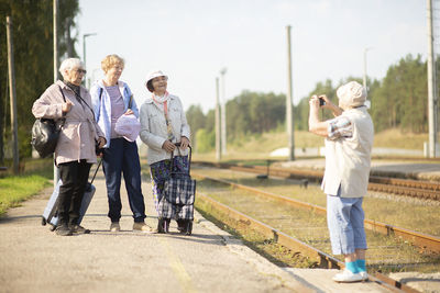 Rear view of people standing on street