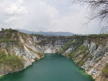 Scenic view of river amidst mountains against sky