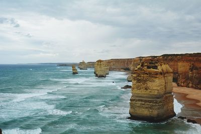 Twelve apostles sea rocks by sea against sky