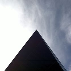 Low angle view of building against cloudy sky