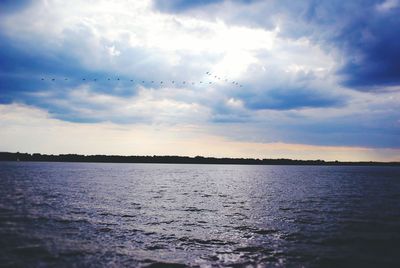 Scenic view of sea against cloudy sky