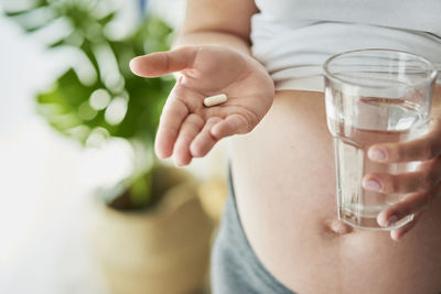 Midsection of man drinking glass