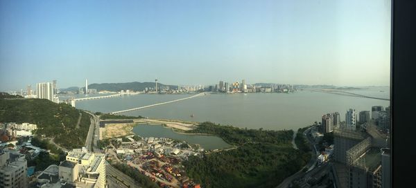 High angle view of bay and buildings against clear sky