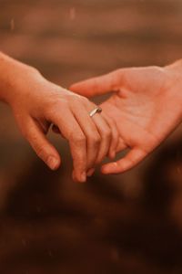 Close-up of couple holding hands