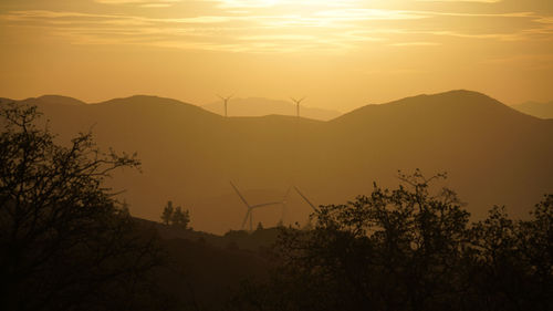 Scenic view of silhouette mountains against sky during sunset