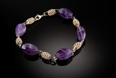 Close-up of pearl jewelry against black background