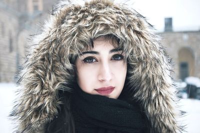 Close-up portrait of young woman wearing warm clothing during winter