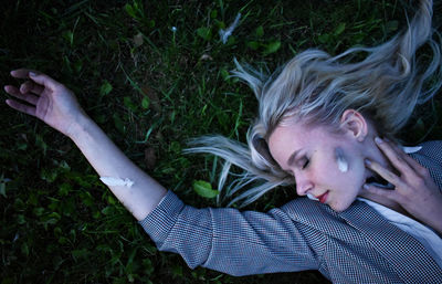 Portrait of woman lying on grass