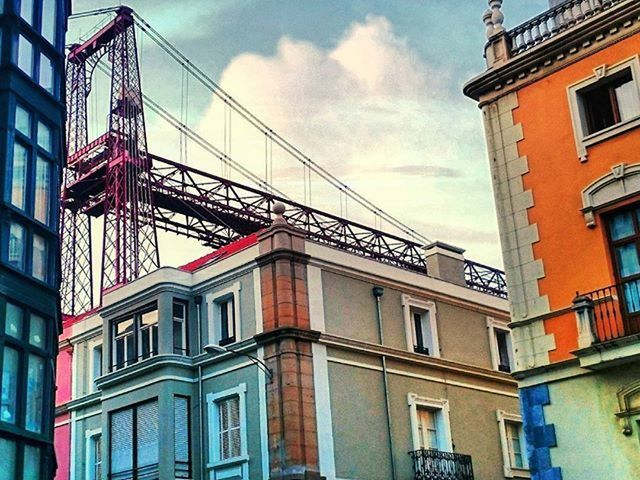 architecture, built structure, building exterior, low angle view, sky, building, city, window, cloud - sky, residential building, cloud, residential structure, day, outdoors, no people, cloudy, city life, balcony, railing, connection