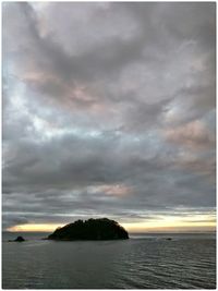 Scenic view of sea against cloudy sky