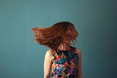 Young woman against colored background