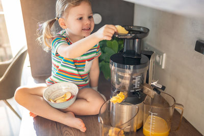 Portrait of cute girl preparing food at home