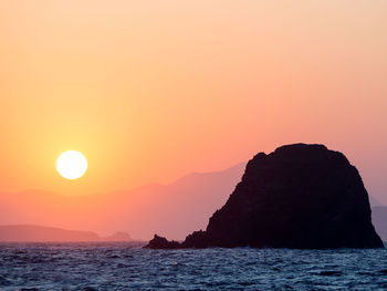 Scenic view of sea against orange sky