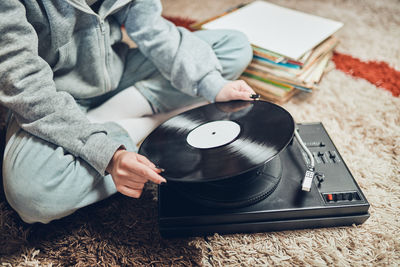 Woman playing music from vinyl record. analog record. retro and vintage style. analog sound. music