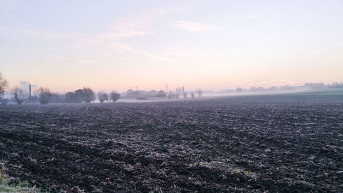 Scenic view of field against sky during sunset