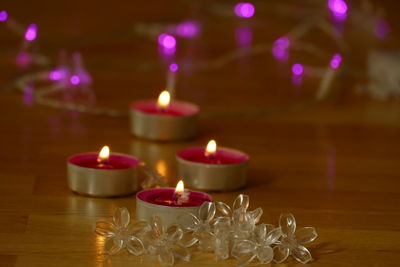 Close-up of lit candles on table