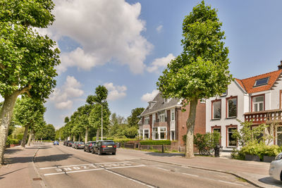 People walking on road against sky