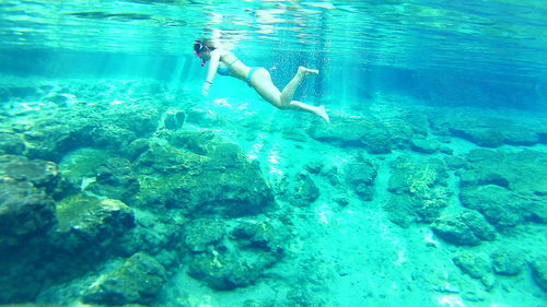 Full length of a young woman swimming in pool