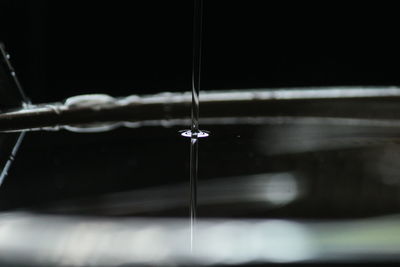 Close-up of water falling in container at night